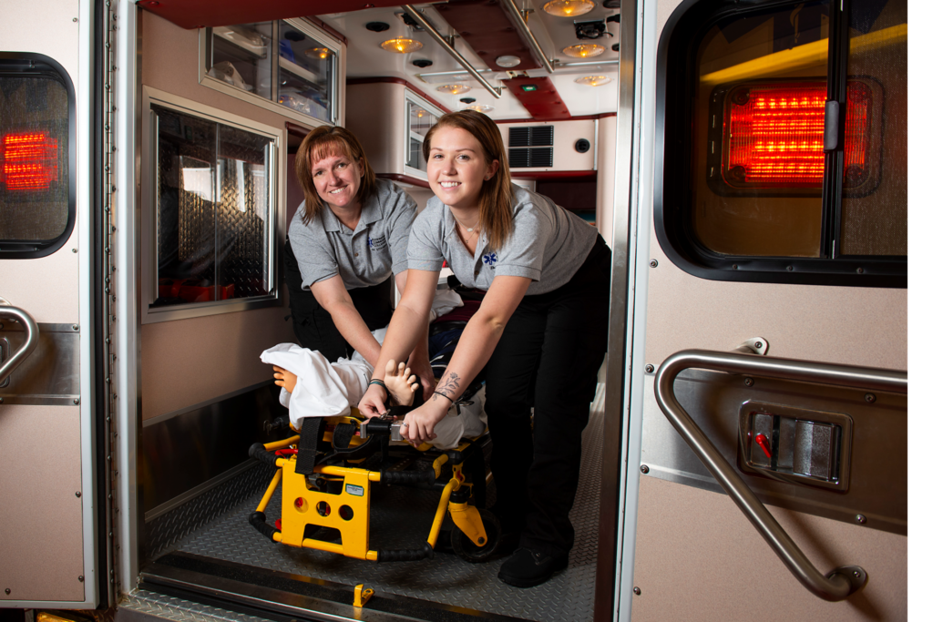 Two EMS students in the back of an ambulance.