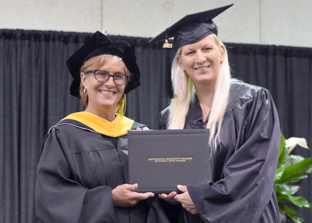 May 2023 RCC graduate accepts her Welding Certificate.