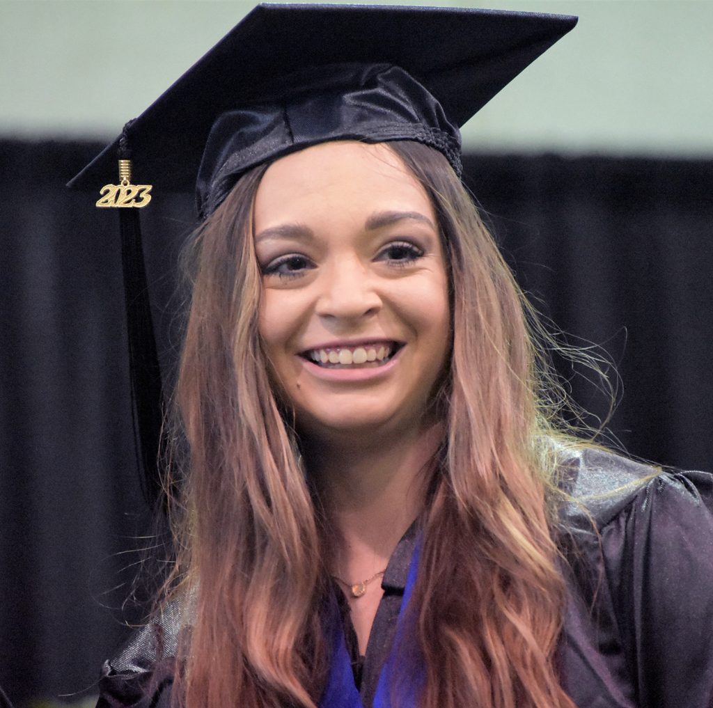 May 2023 RCC graduate smiles from stage