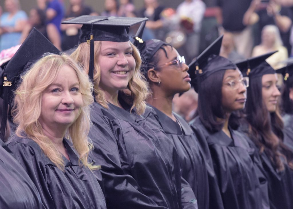 May 2023 RCC graduates smile from their seats.