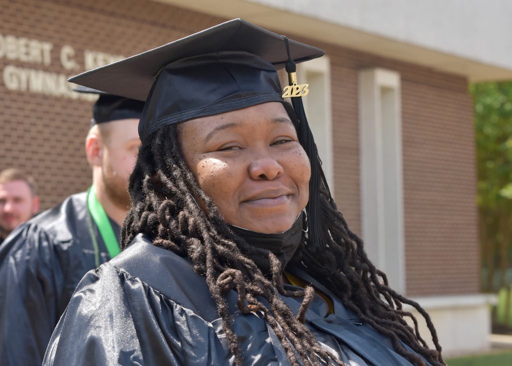 May 2023 RCC graduate smiles after the ceremony.