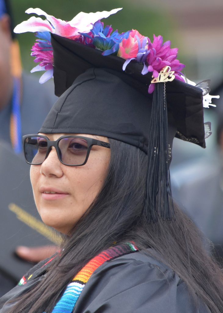 May 2023 RCC graduate looks for relatives after the ceremony.