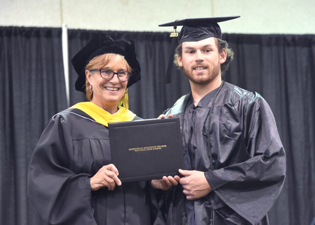 May 2023 RCC graduate accepts his credential.