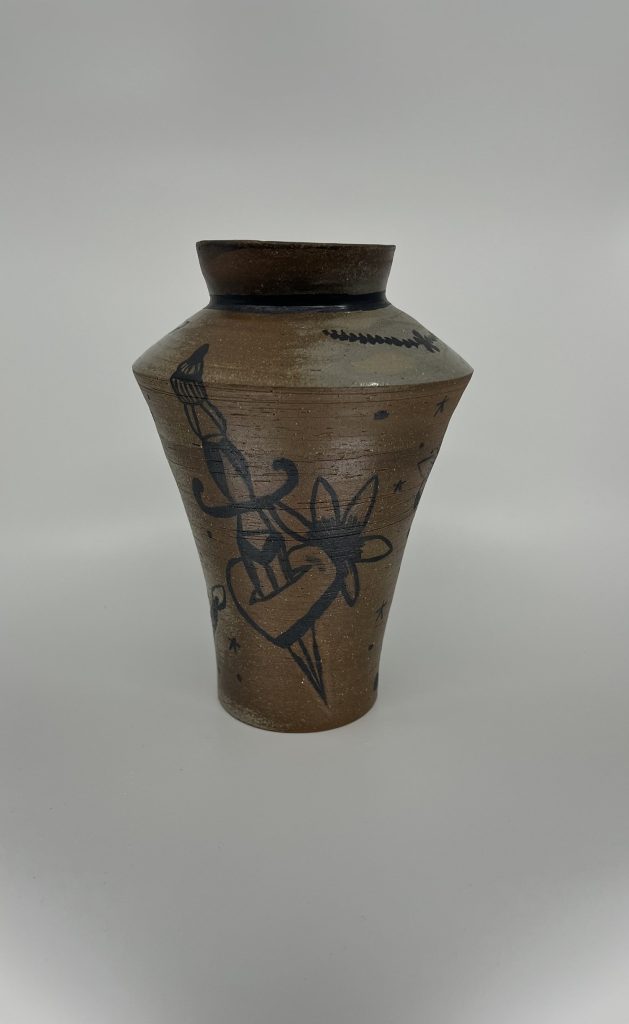 2021 Fall Art Show - Torri Parson. Tattoo Vessel. Ceramic and underglaze. 7x7x12