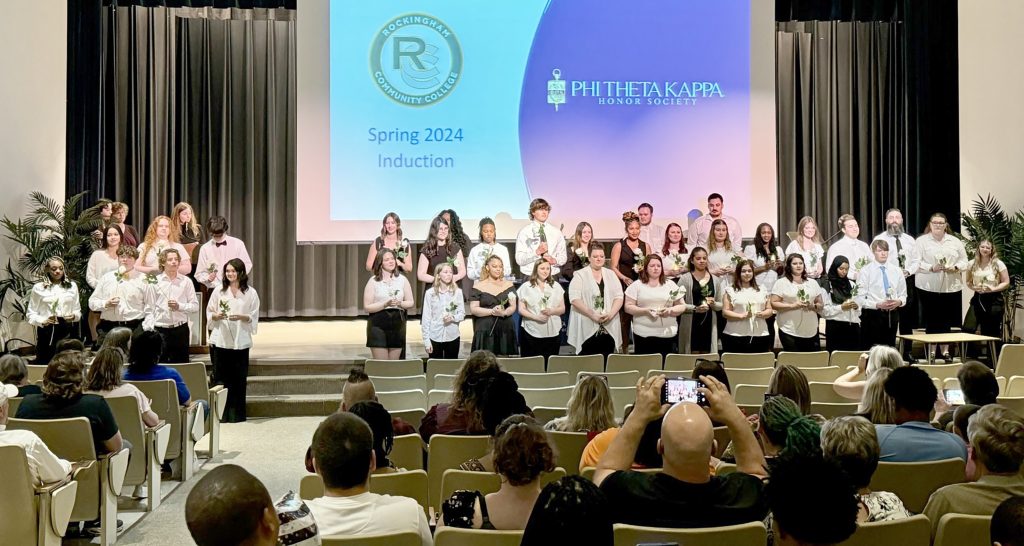 PTK inductees on stage