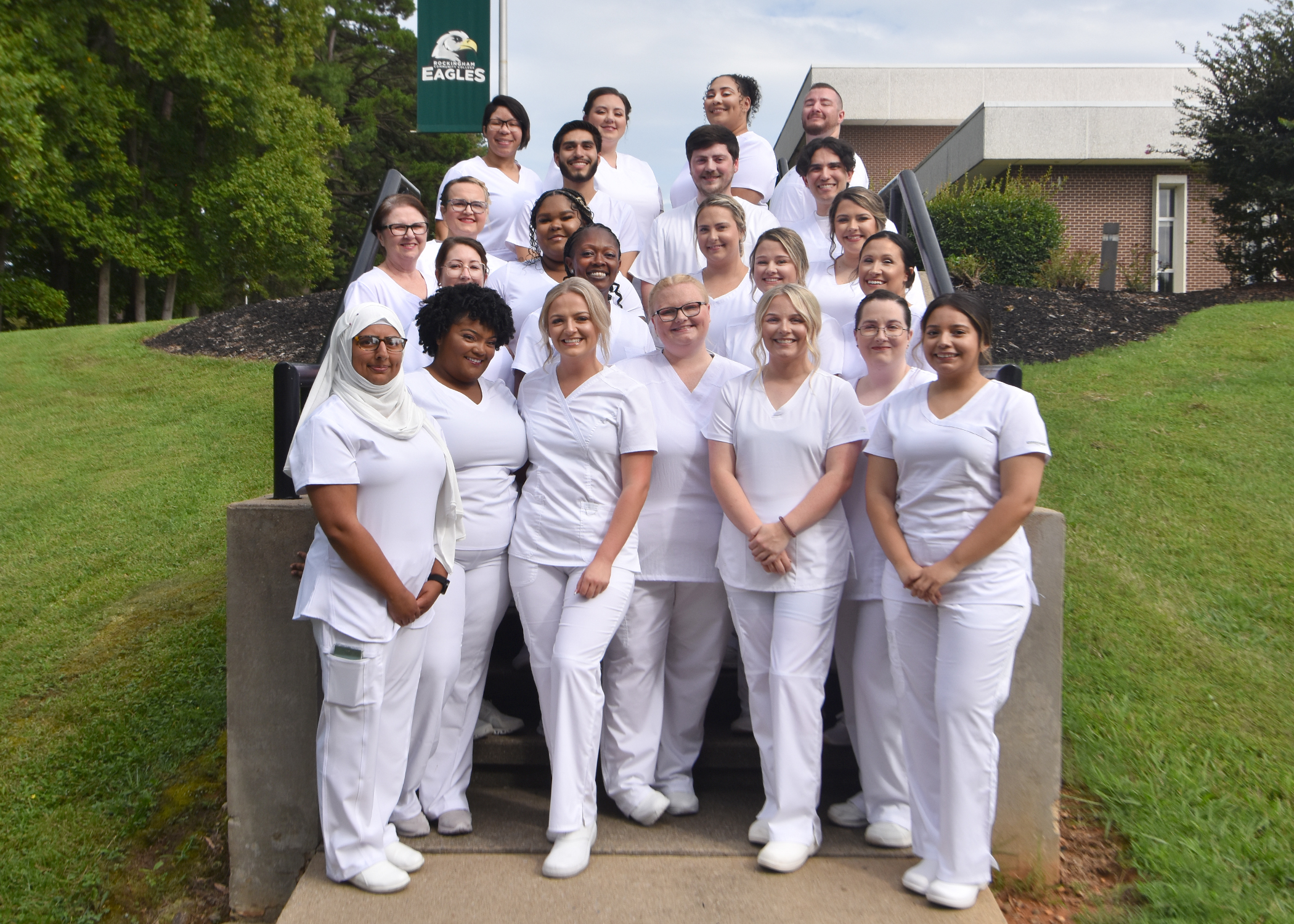 A group of Practical Nursing students posing on steps.