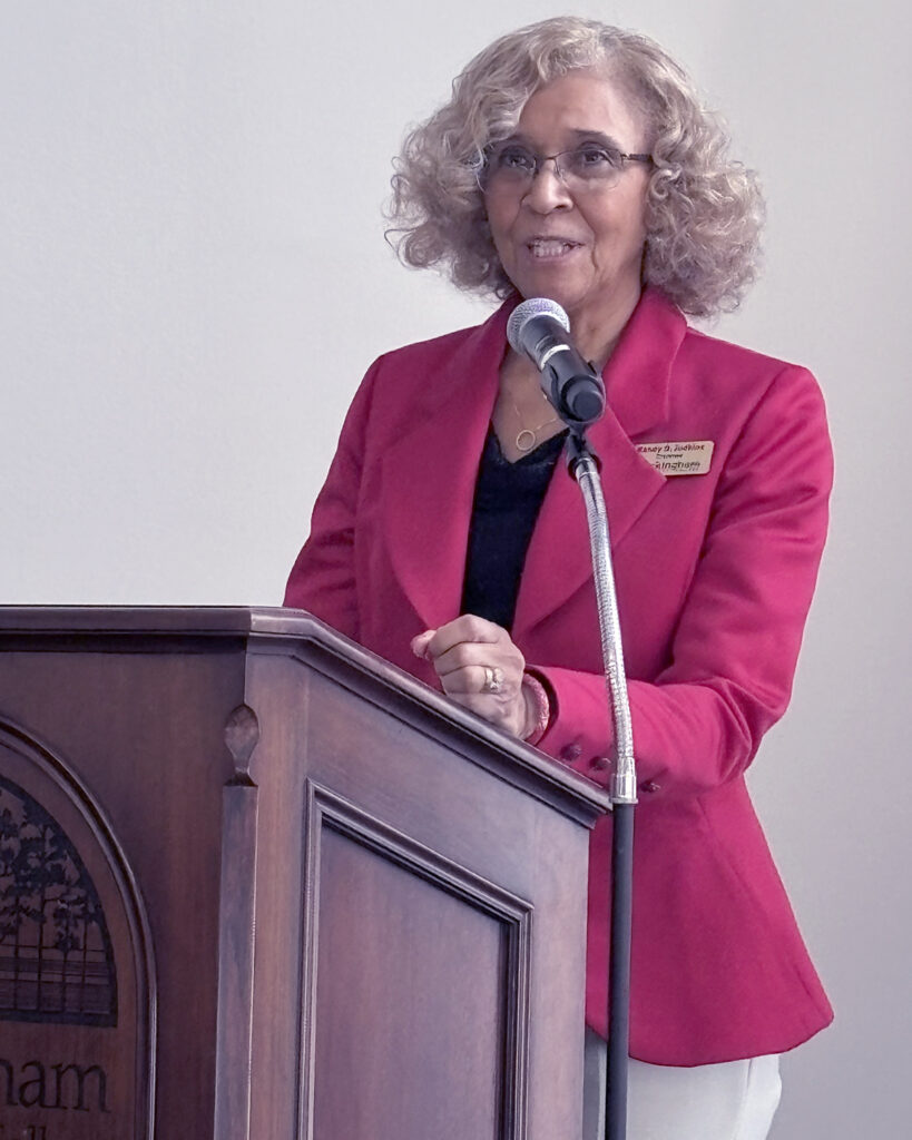 A woman speaks at a podium.