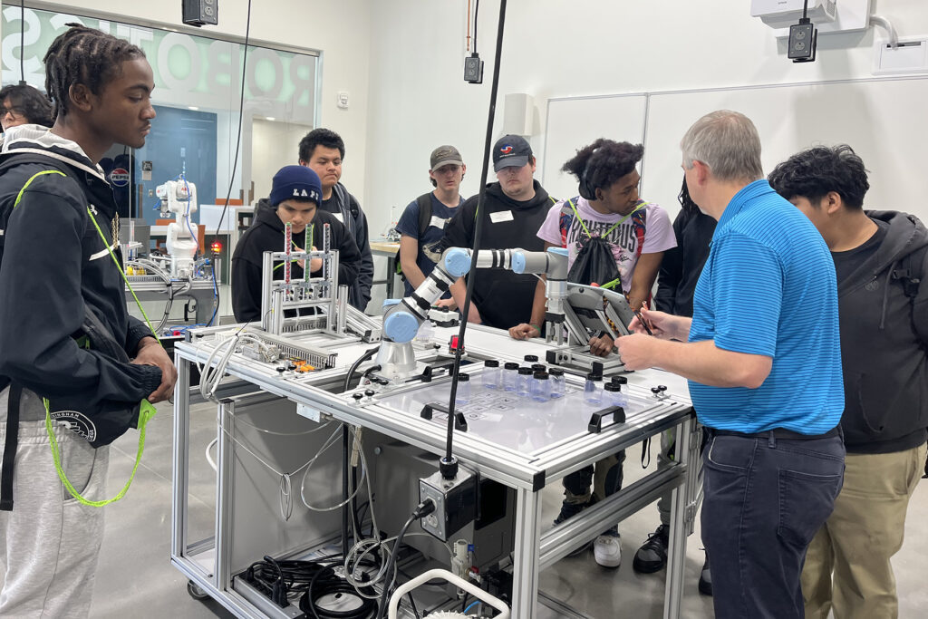 High school students check out a robotics lab.
