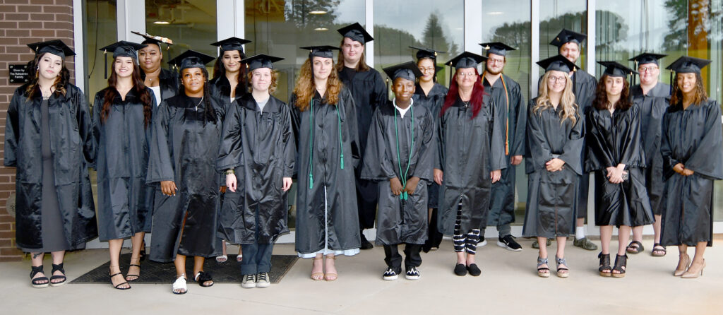 Group shot of 18 graduates.