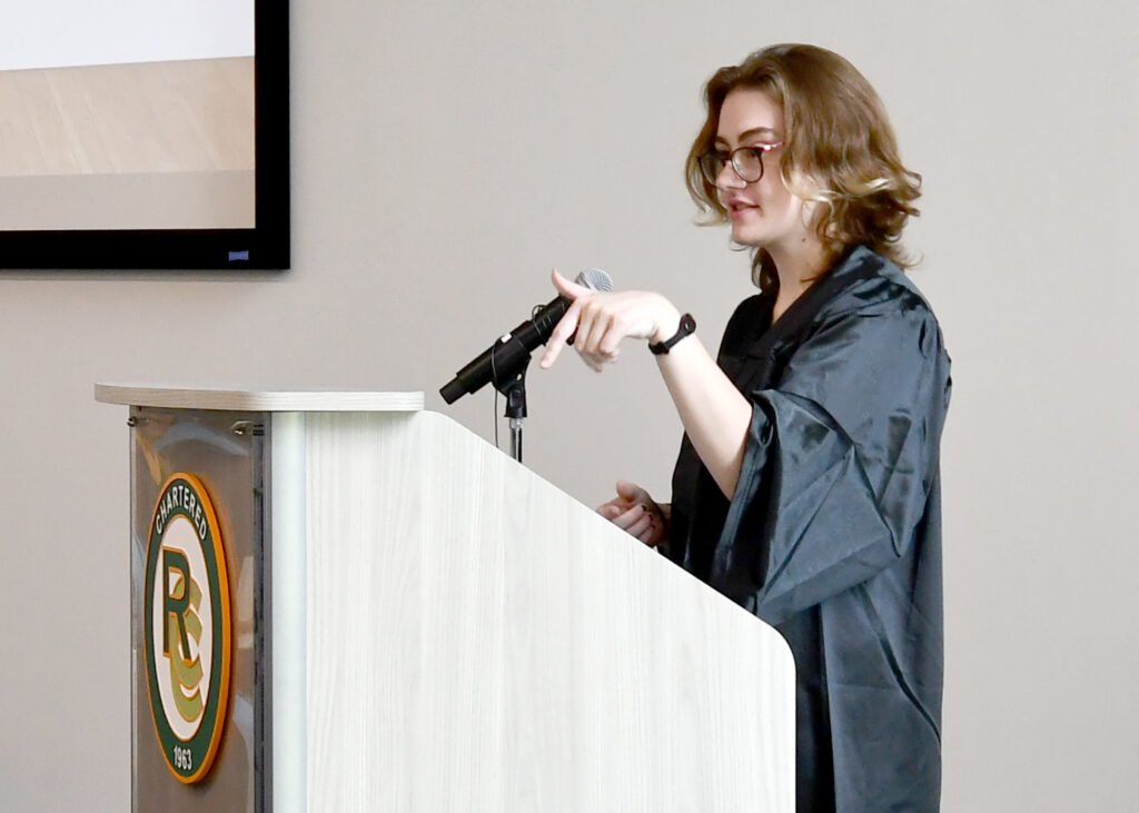 A female speaks at a podium.