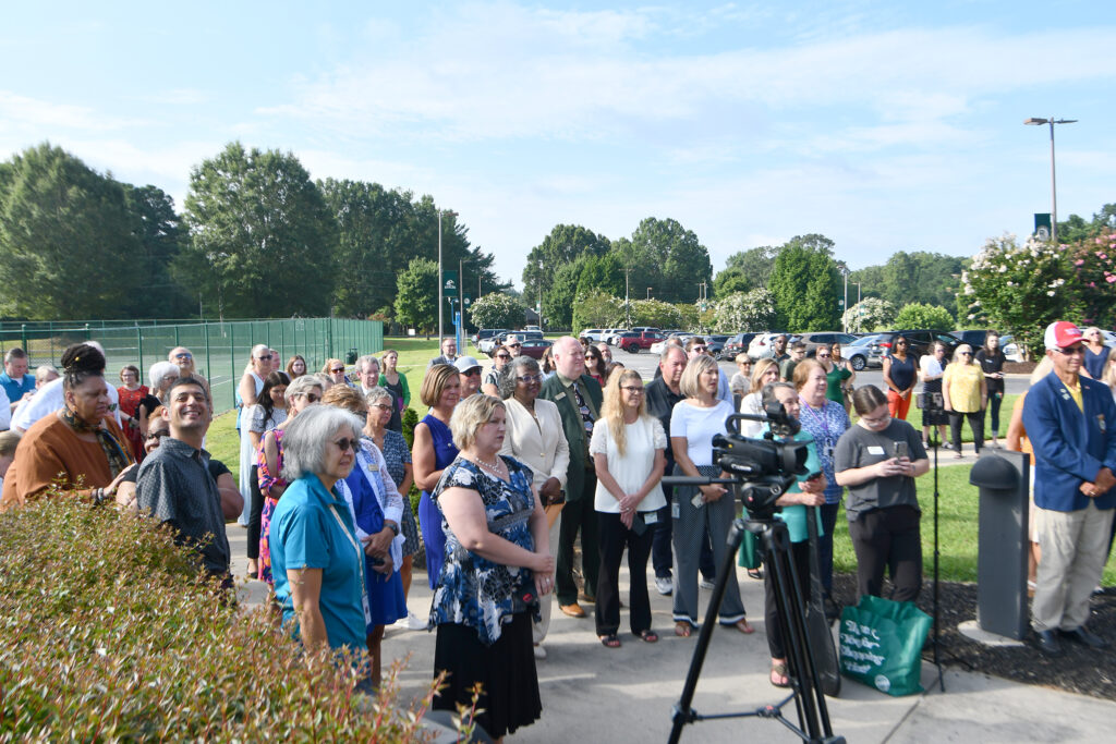 A crowd gathers outside