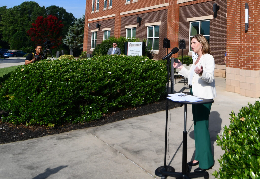 A lady speaks at a podium