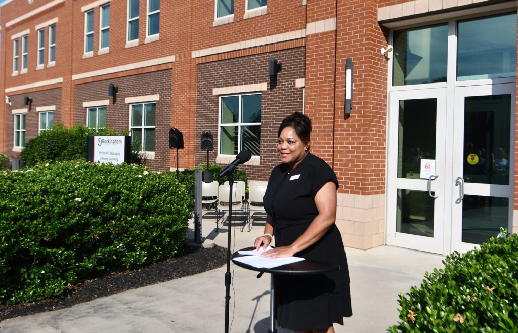 A lady speaks at a podium