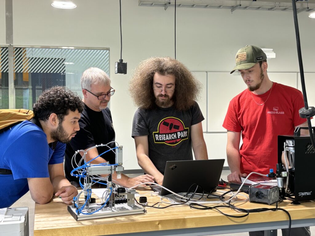 Teacher working with mechatronics students