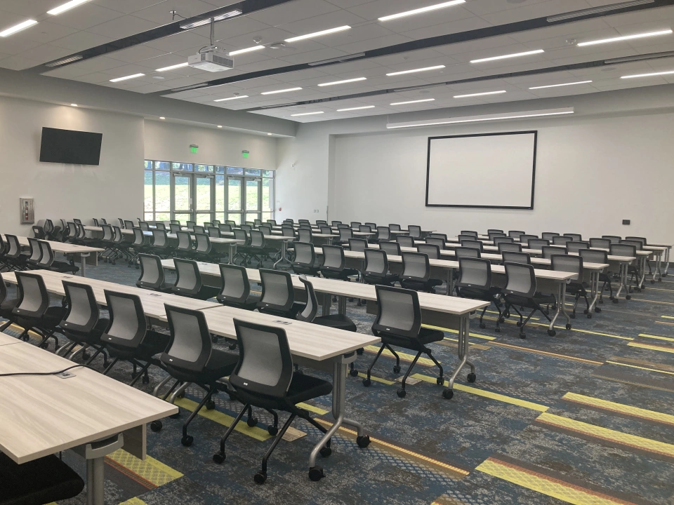 Center for Workforce Development meeting room. Chairs and tables lined up in a row facing the front.