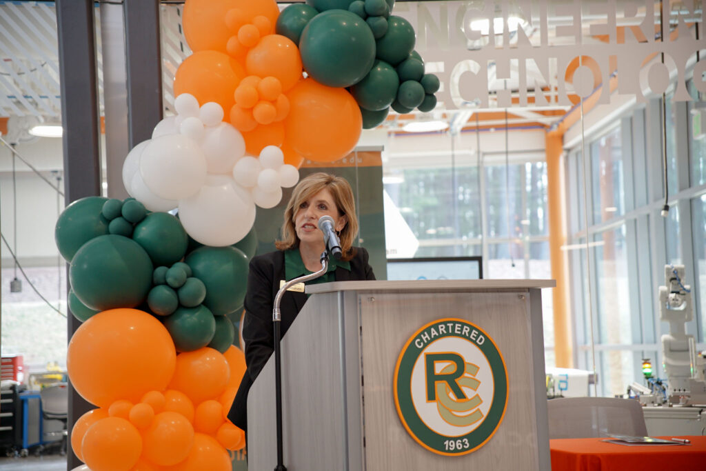 A woman speaks at a podium