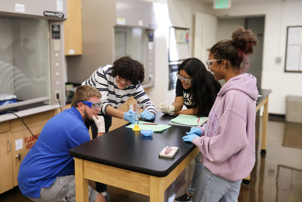 RCC Students around a lab table.