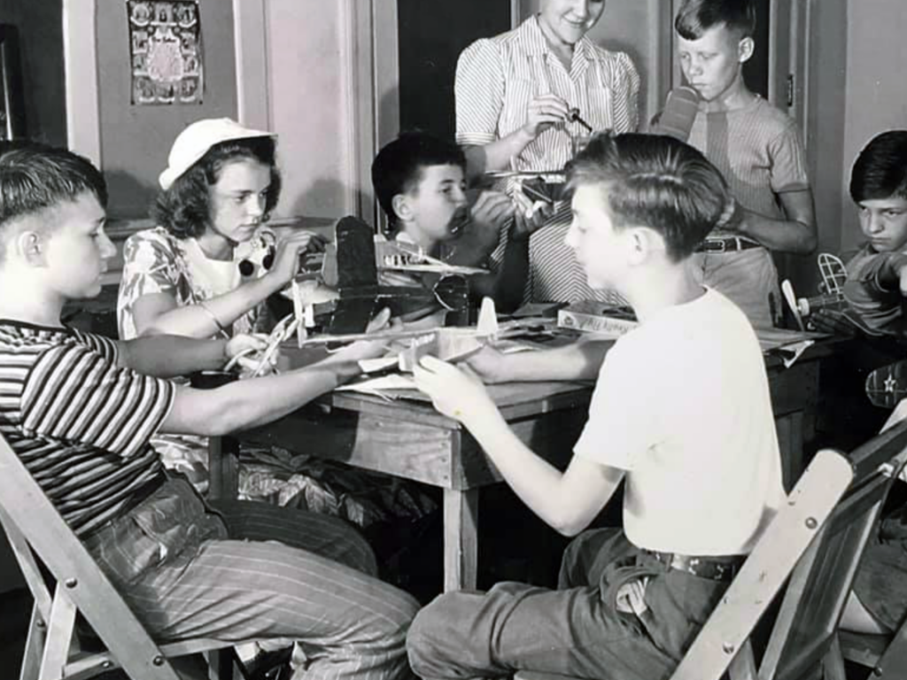 Children doing crafts at a table at church in the 1940s.