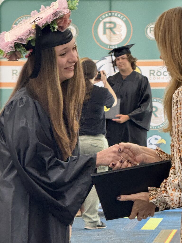 CCR Graduation shaking hands with the Vice President of Student Life.
