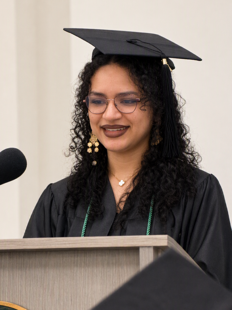 CCR Graduate speaking at a podium.