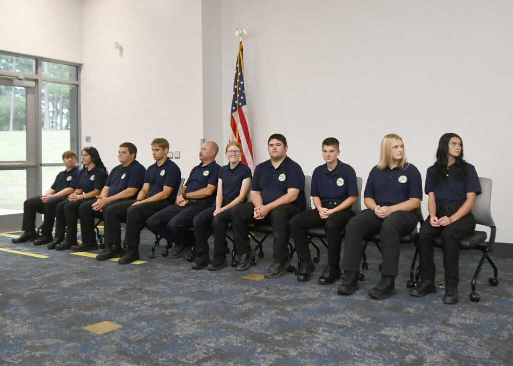 Fire Academy cadets listen to a speaker during their graduation ceremony.
